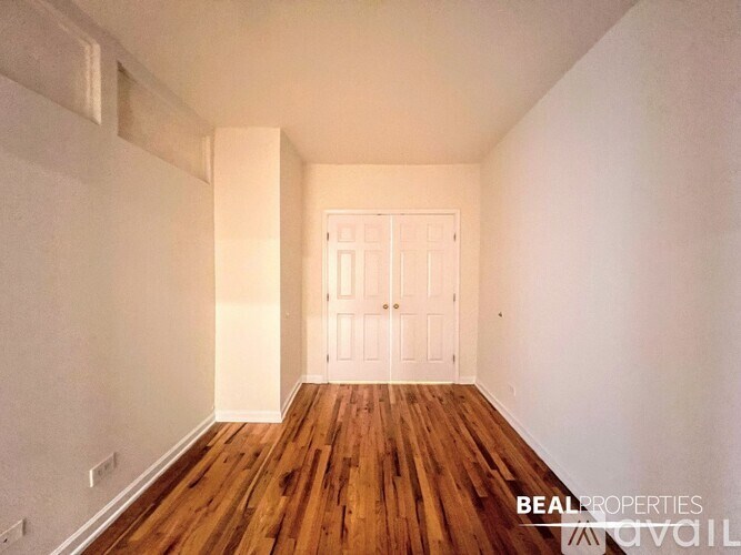 A room with wooden floors and a white door.