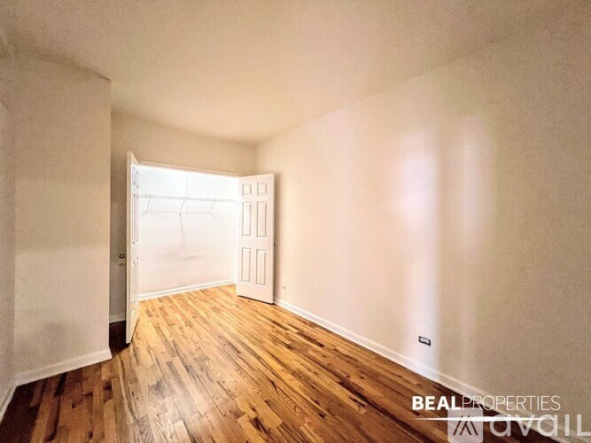 A room with wooden floors and a white door.