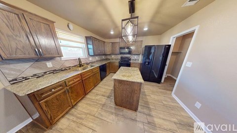 A kitchen with wooden cabinets and a granite countertop.
