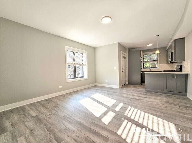 A sunny room with wooden floors and a window.