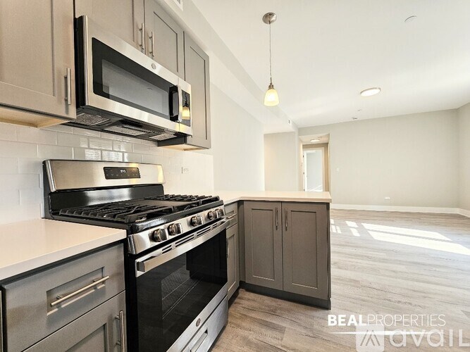A modern kitchen with a stove top oven and microwave above it.