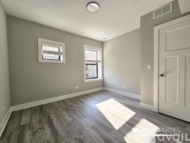 A room with a door, a window, and a ceiling light.