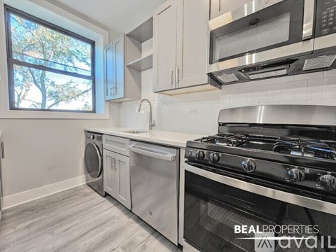A modern kitchen with a stainless steel oven and microwave.