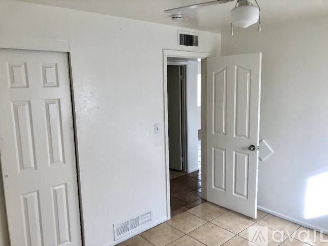 A white door is open to a hallway.