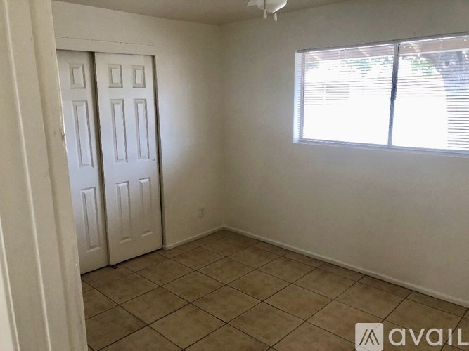 A room with two doors and a window.