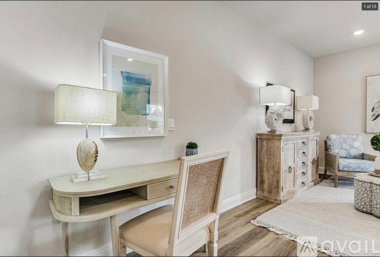 A room with a desk, chair, and a cabinet.