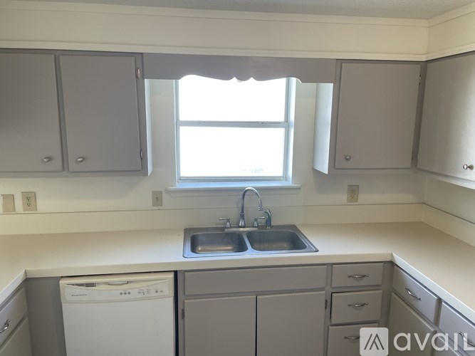 A kitchen with a window above the sink.