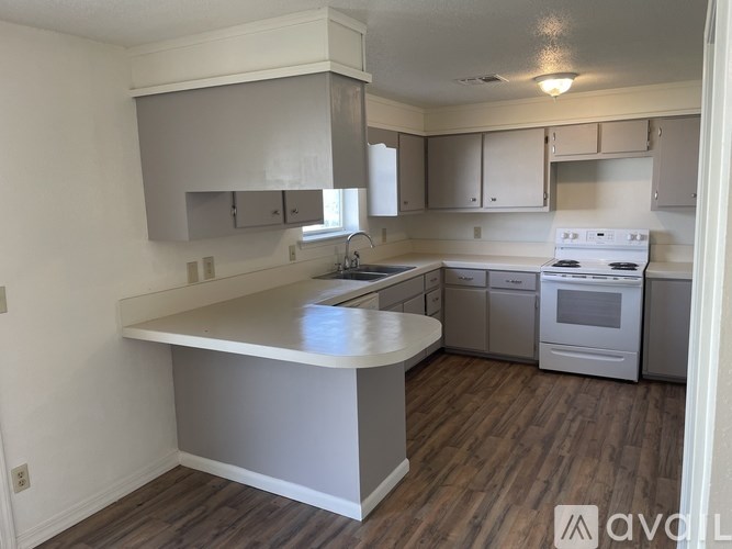 A kitchen with a white countertop and stove.