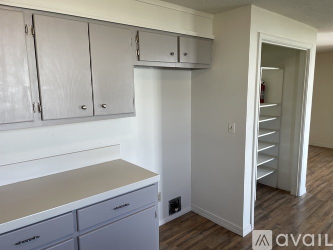A kitchen with white cabinets and a countertop.