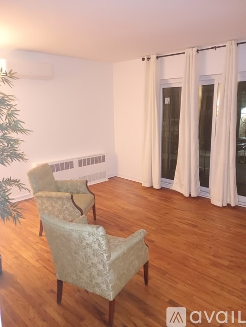 Two chairs are placed in a room with wooden floors.