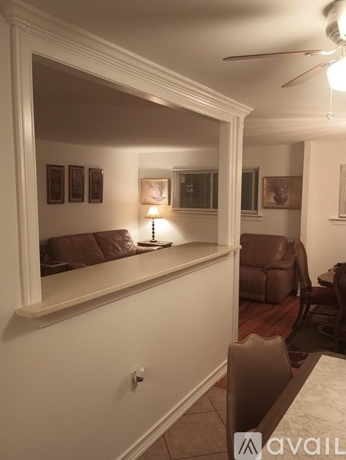 A living room with a large mirror on the wall.