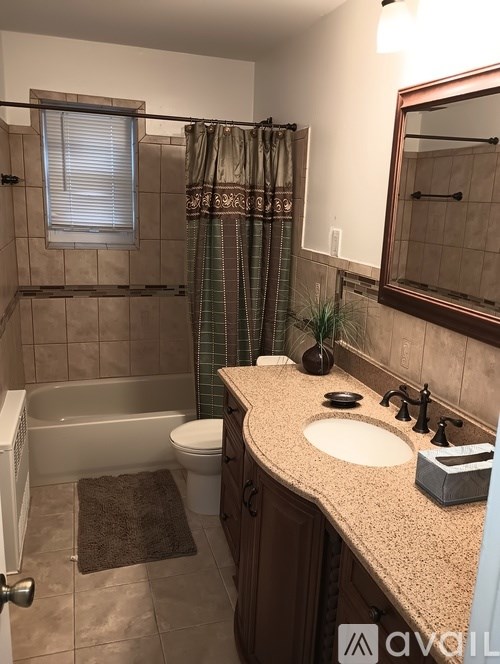 A bathroom with a sink, toilet, and bathtub.