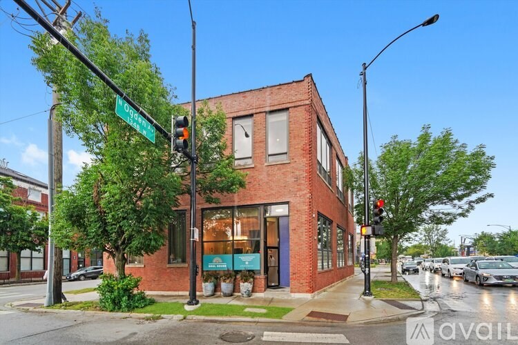 A red brick building is located at the corner of a street.