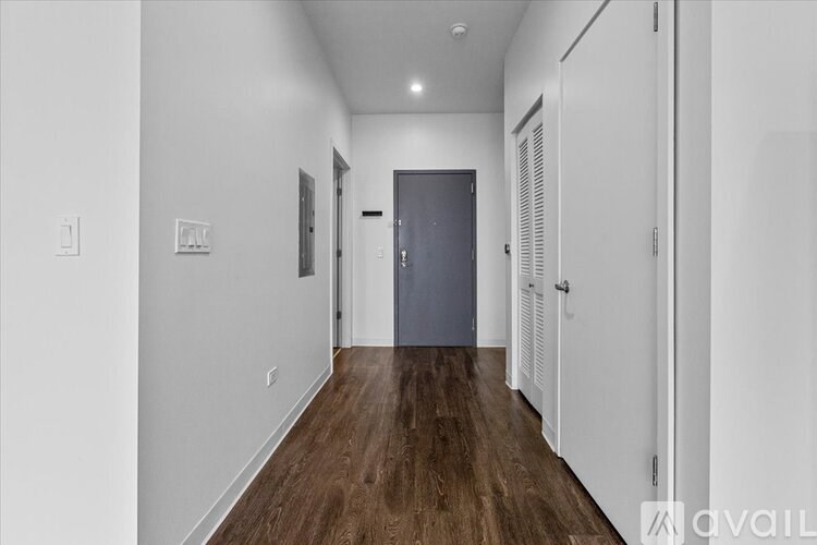 A long hallway with a door at the end.