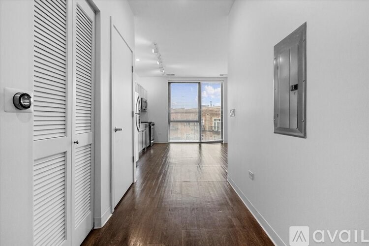 A long hallway with a view of the outside through a window.