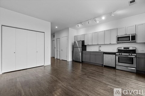 A spacious kitchen with white cabinets and stainless steel appliances.