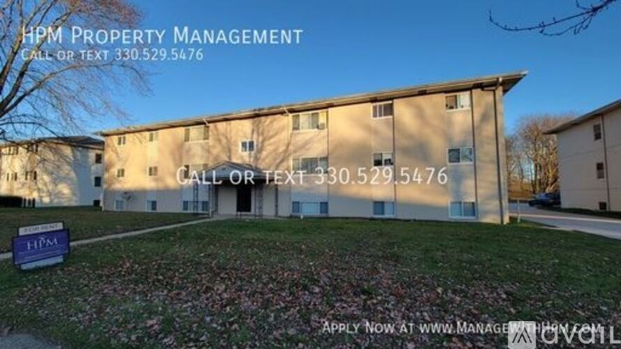 HPM Property Management building with a sign in front of it.