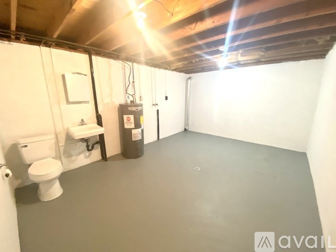 A small, empty room with a toilet and sink.