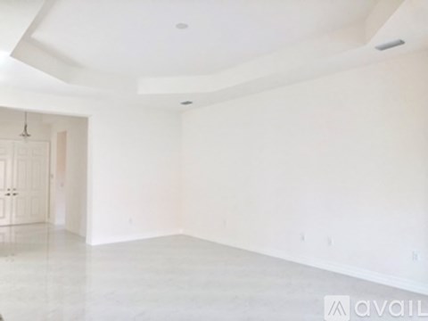 A spacious room with a white ceiling and floor.