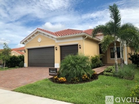 A two-story house with a garage and a sign that says "For Sale".