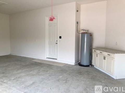 A room with a door, a radiator, and a cabinet.