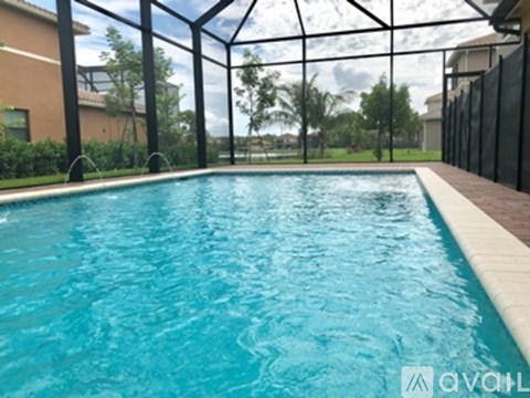 A pool with a glass ceiling and a fence around it.