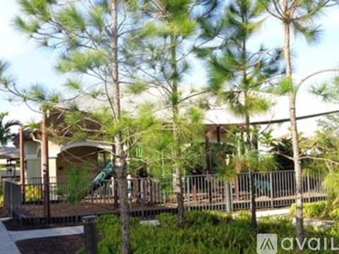 A playground area with a slide and a wooden fence.