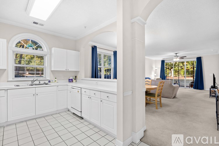 A kitchen with white cabinets and a large island.