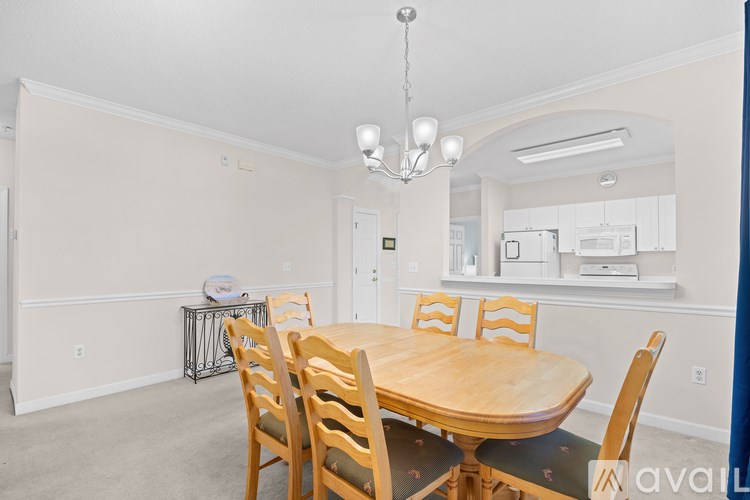 A dining room with a wooden table and chairs.