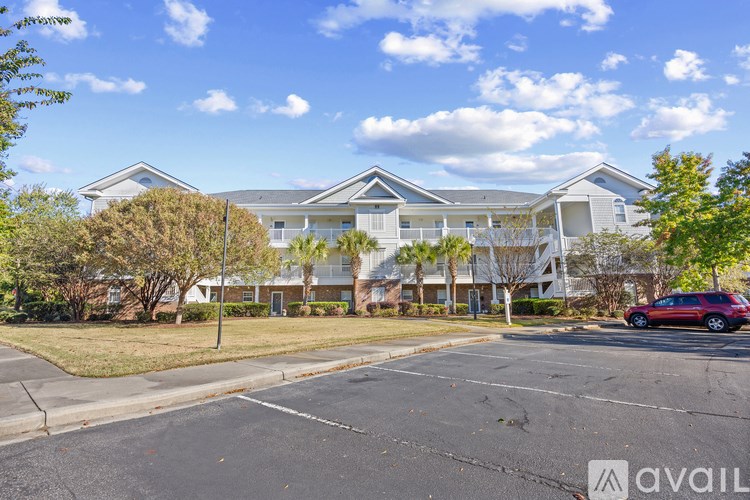 A large building with a parking lot in front of it.