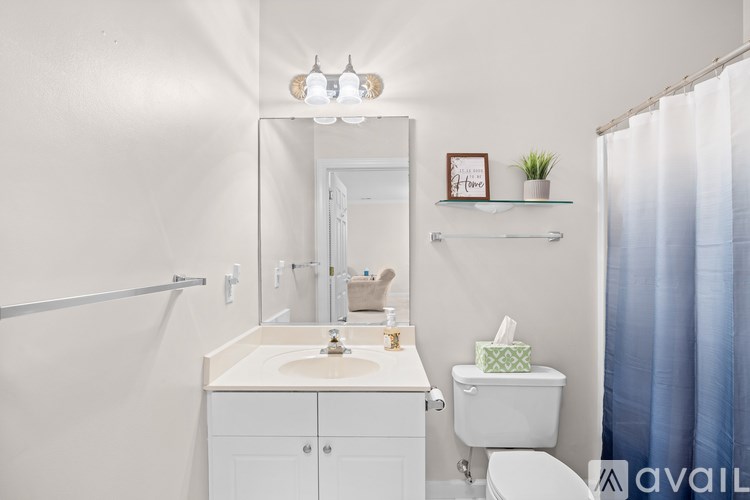 A bathroom with a white sink and toilet.