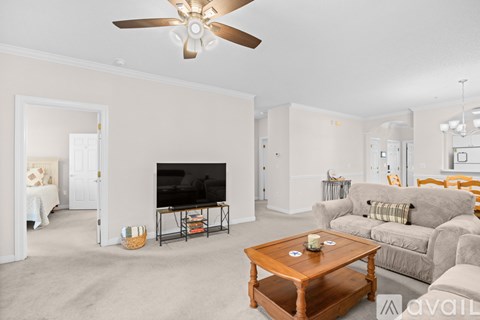 A living room with a television and a couch.