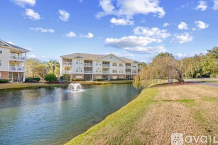 A residential area with a lake and a fountain.