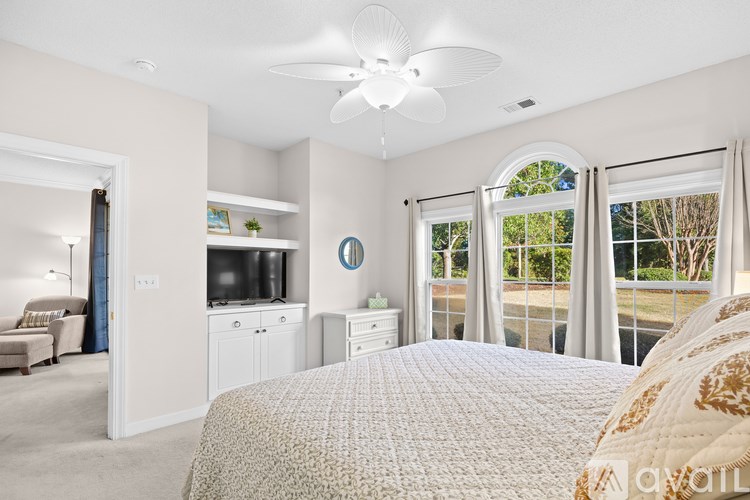 A bedroom with a large bed and a television.