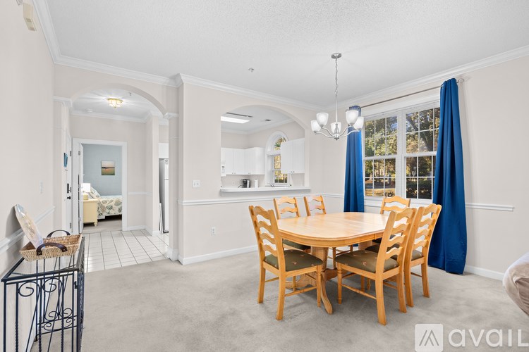A dining room with a round table and chairs.