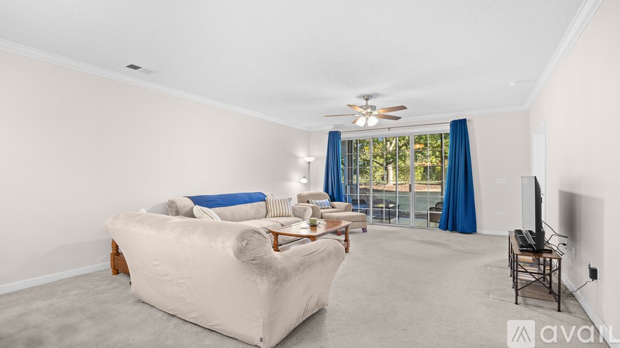 A living room with a large bed and a television.