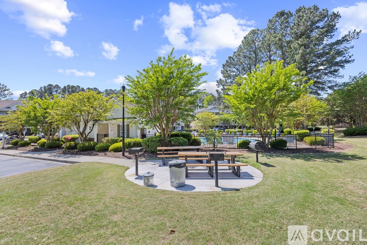 A park with a bench and a tree.