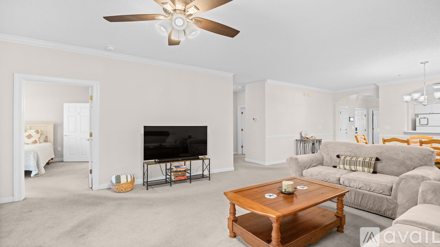 A living room with a television, couch, and coffee table.