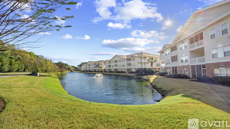 A row of houses with a body of water in front of them.