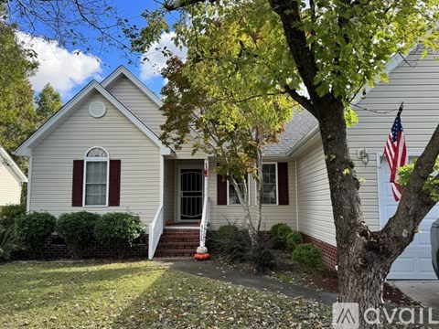 A house with a flag on the front lawn.