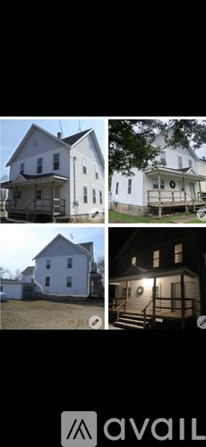 A white house with a porch and a deck.