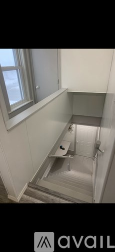 A bathroom with a toilet and a window.