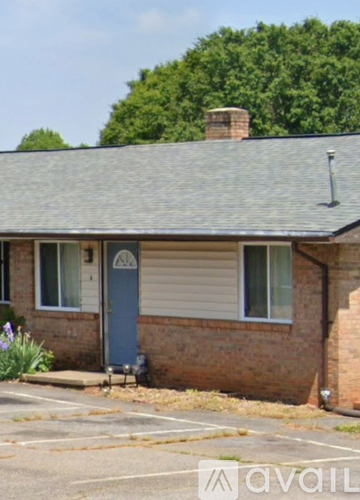 A house with a blue door and a grey roof.