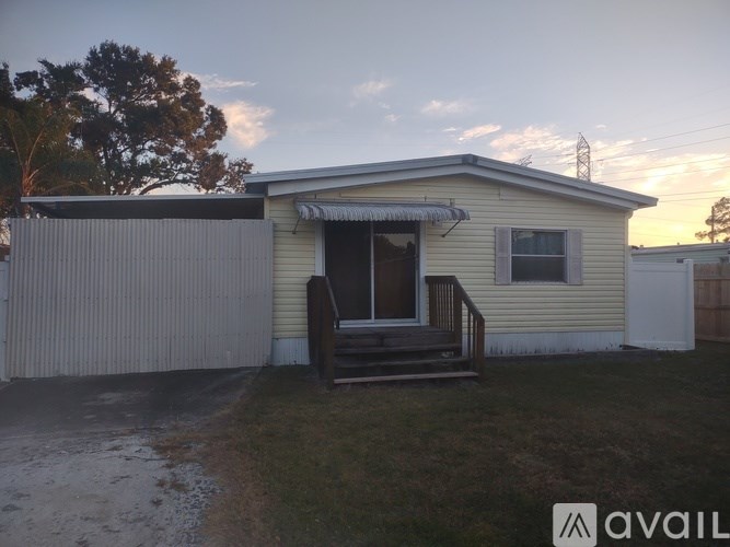 A house with a porch and a garage door.