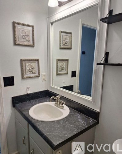 A bathroom with a sink and a mirror.