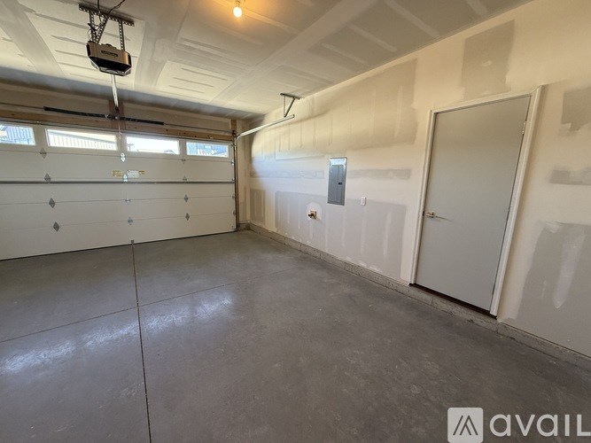 A spacious garage with a concrete floor and white walls.