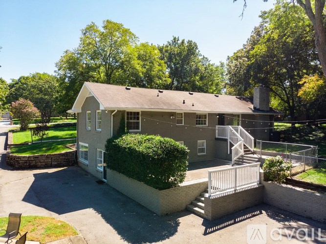 A house with a grey roof and a white fence.
