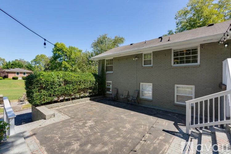 A house with a grey roof and a white fence.