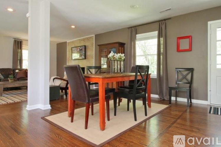 A dining room with a table set for four.