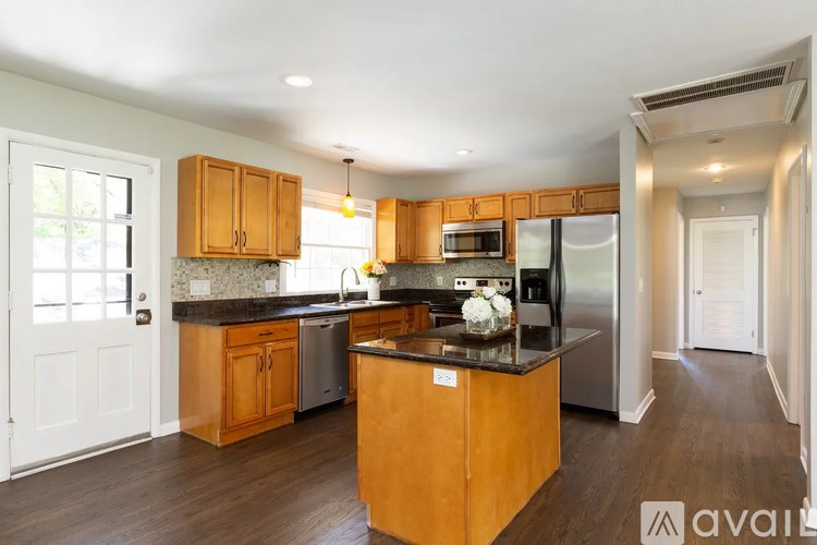 A kitchen with wooden cabinets and a central island.